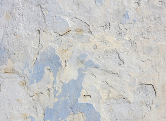 blue concrete wall with peeling old paint, texture