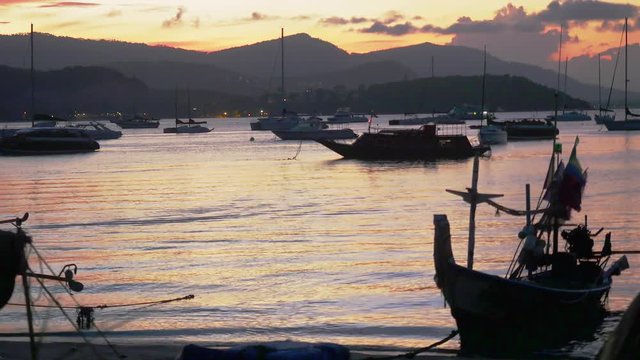 Sunset in the peaceful fishing port. Fishing boats anchored in a peaceful port at the sunset. 3840x2160, 4k