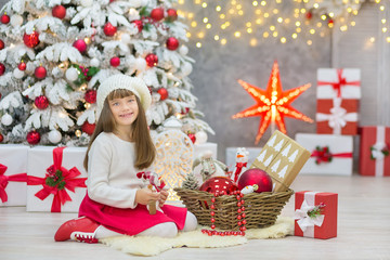 Christmas Family together cellebrating holiday New Year daughter and mother close to white xmas tree with snow and red balls toys