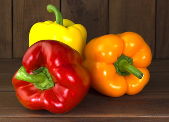 Juicy beautiful Bulgarian pepper on a wooden background
