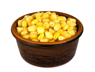 Sweet corn kernels in bowl over white