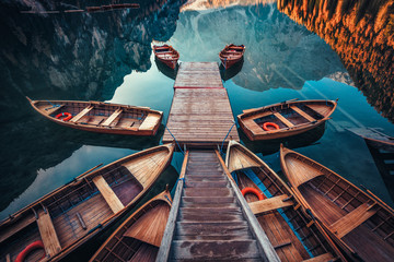 Boats on the Braies Lake ( Pragser Wildsee ) in Dolomites mountains, Sudtirol, Italy - obrazy, fototapety, plakaty