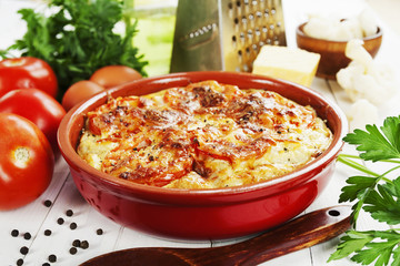 Cauliflower baked with tomato, cheese and eggs