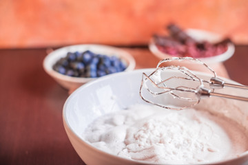 Whipped egg whites for meringue. Mixing white egg cream in bowl with motor mixer, baking cake. Anna Pavlova meringue. Whipped egg whites and sugar powder. Baking dessert concept