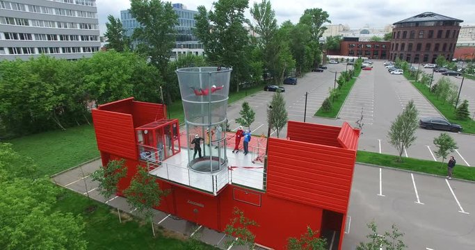 Drone view flying skydiver in training wind tunnel. Extreme parachuting