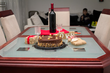 Fototapeta na wymiar Birthday cake with gifts and wine on the table. A beautiful day