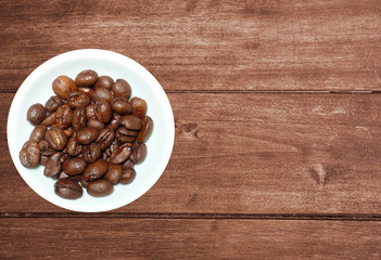 variety of tea in strands and coffee beans on rustic wooden background