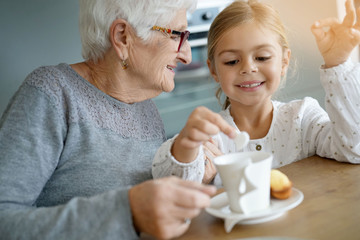 Little girl having tea time with grandma
