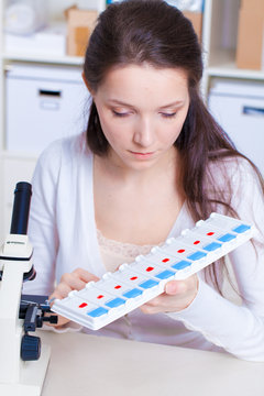 A girl technician in a medical laboratory