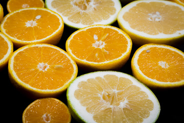 Citrus fruits (orange, lemon, grapefruit, mandarin, lime) on the dark background. Fruit food background. Fresh citrus fruit assortment