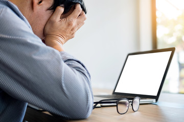 stressed businessman Feeling sick and tired while sitting at his working place in office, deadline...