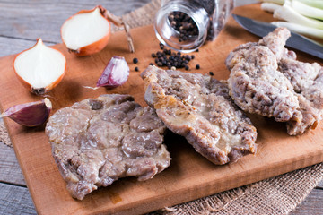 Fried pork fillet on wooden desk