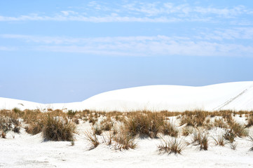 Blue sky and clouds and white sand on White Sands National Monument in New Mexico