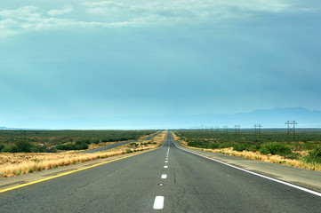 Straight road with electric lines 