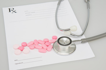 Close up stethoscope and pills on blur rx prescription concept