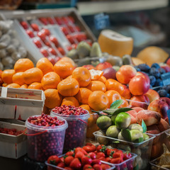 Sale of fresh organic different kinds of fruits in farmer's bazaar, open showcases of vegetable market. Vegetarian concept, diet, detox, organic vitamins
