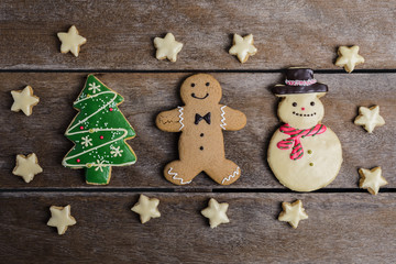 Festive Christmas Cookie and New Year in the shape of Christmas tree, Gingerbread man, snowman, Snowflake, star on wooden table