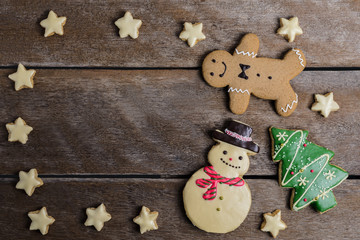 Festive Christmas Cookie and New Year in the shape of Christmas tree, Gingerbread man, snowman, Snowflake, star on wooden table