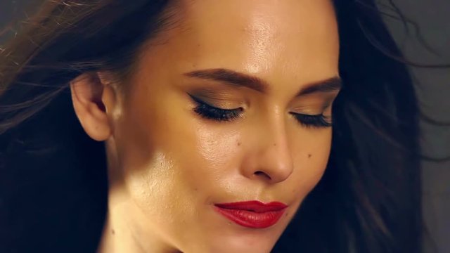 Hair model on wind of beautiful girl with blowing hair . Slow motion closed and open eyes.