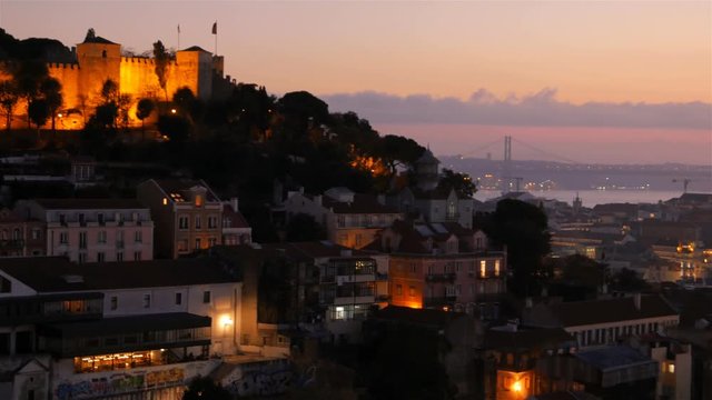 An exquisite panoramic dusk view of the Castelo de Sao Jorge Castle, Alfama, Downtown, Tagus river, Cristo Rei and the Ponte 25 de Abril suspension bridge in Lisbon, Portugal.