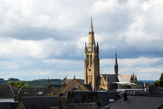 church of arlon over the roofs of the old town against a cloudy sky with copy space, belgium, europe