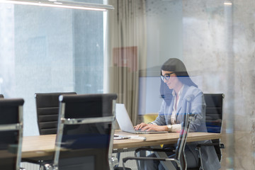 businesswoman using a laptop in startup office