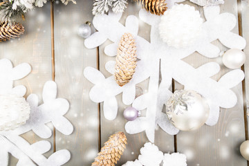 Decorative snowflake, Christmas tree and cone on wooden background. Christmas greeting card. Copy space. Top view. Flat lay.