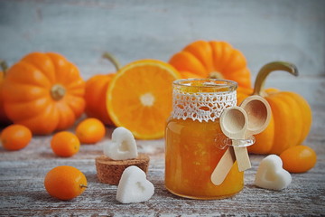 pumpkin jam with oranges on a vintage wooden table and shaped sugar