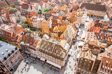 Top cityscape view on the cathedral square crowded with people in the old town of Strasbourg city,...