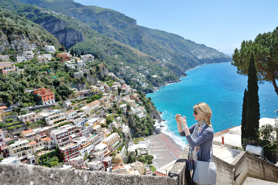 Tourist taking photos with cell phone in Positano, Amalfi coast, Italy