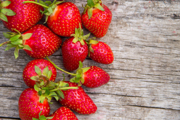 Ripe fresh strawberries on rustic wooden background with copy space. Top view