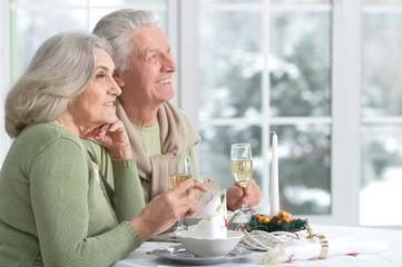 couple celebrating Christmas with champagne 