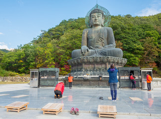 SOKCHO, SOUTH KOREA - October 20, 2013: Prayers at giant statue of Buddha in the Sinheungsa Temple...