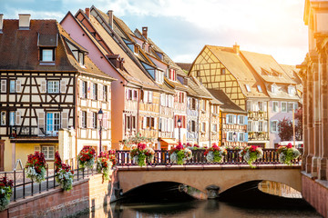 Landscape view on the beautiful colorful buildings on the water channel in the famous tourist town Colmar in Alsace region, France - obrazy, fototapety, plakaty