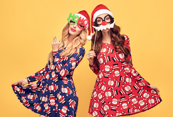New Year. Young Woman with Christmas Props in Holiday Fashion Santa hat Having Fun Happy Smiling....