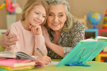 grandmother and granddaughter doing homework