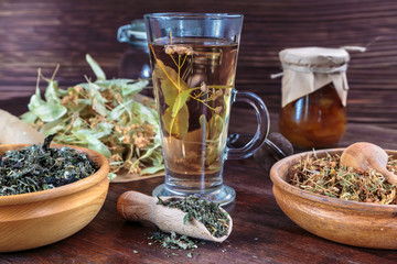 linden tea on a background of dried lime flowers, lemon balm and St. John's wort
