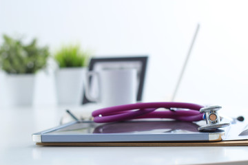 Medical stethoscope , laptop, folder on the desk in hospital