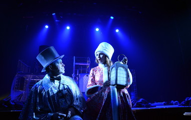 a guy and a girl in an old theatrical costumes with a lantern