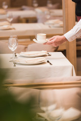 waiter serving cup of coffee