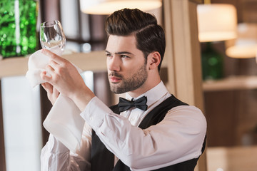 waiter looking at clean wineglass