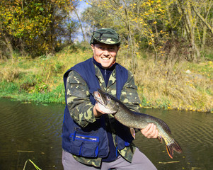 Fisherman with a big pike