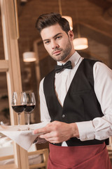 waiter holding tray with wineglasses