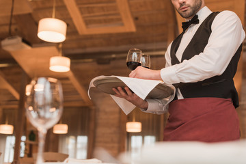 waiter holding tray with wineglasses