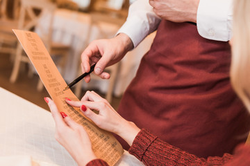 customer asking waiter about menu
