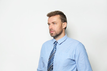 Attractive man in formal suit on white background