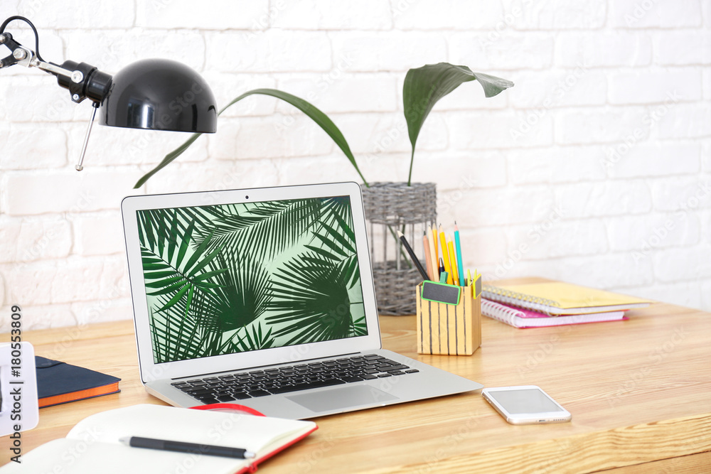 Sticker Comfortable workplace with laptop on table