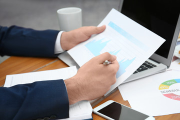Marketing manager working with diagram at table