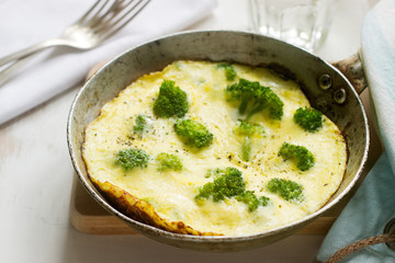 Omelette with broccoli and cheese served with bread toasts and lemonade.