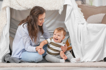 Mother with baby boy playing at home